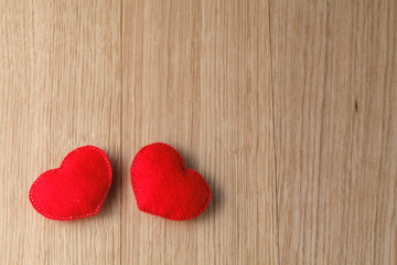 Valentines day toy hearts on wooden table. View with copy space