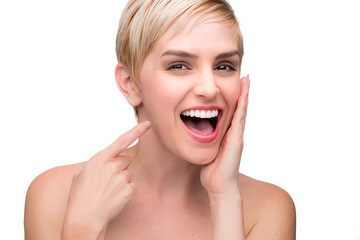 Cute fun laughing female with perfect white teeth straight smile pointing at mouth