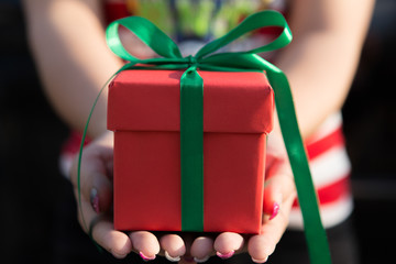 Women hand holding red gift box
