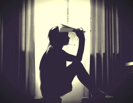 The silhouette of stressed and depressed woman worried about her studies
