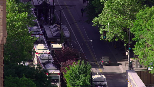 Two UTA Trax trains arrive at and depart from the station