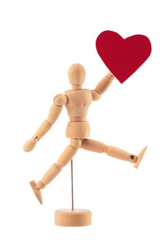 Wooden man toy statue holds red heart studio isolated