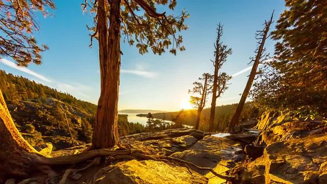 Tilting shot of the sunrise over Emerald Bay in Nevada with lens flare
