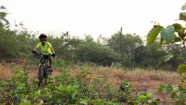 Teenage boy off road cycling in country side