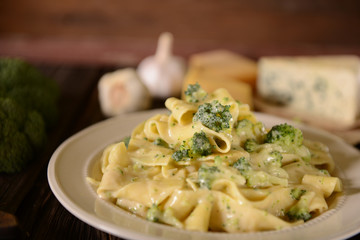 Pappardelle pasta with four cheese sauce and broccoli