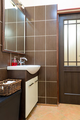 laundry basket near the sink in the bathroom