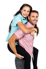 Smiling man carrying his girlfriend on back 