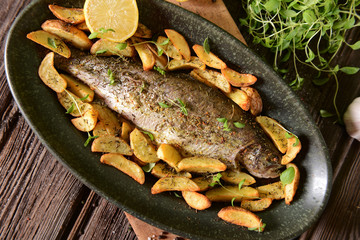 Roasted trout with potatoes in thyme