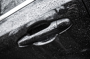 Black shining luxury car fragment, closeup photo