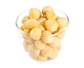 salted macadamia nuts isolated on white