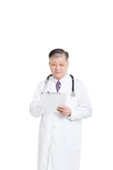 Fototapeta premium old asian man doctor writing on clipboad