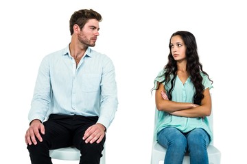 Obraz premium Couple sitting on chairs not talking after argument