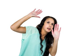 Scared woman raising hands