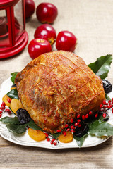 Baked pork with dried apricots on christmas table