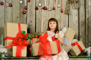 girl with gifts under a New Year's fir-tree