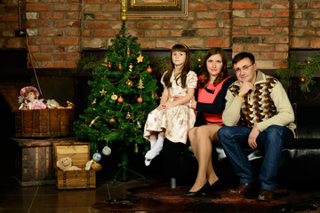 Family new year's eve around the Christmas tree