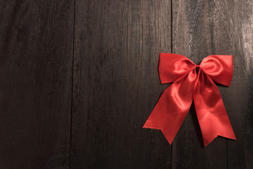 Red bow on old wood