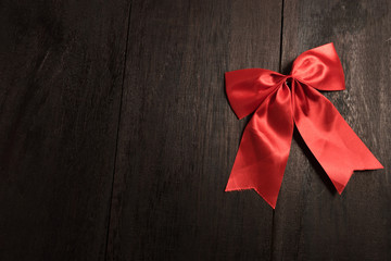Red bow on old wood