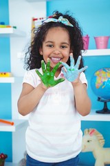 Cute girl showing her paint covered hands