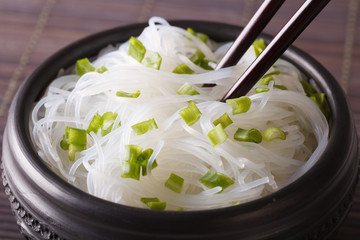 Cellophane noodles with green onions in a bowl closeup. horizontal
