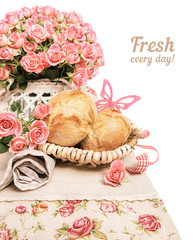 Fresh breakfast buns with roses on white, text space