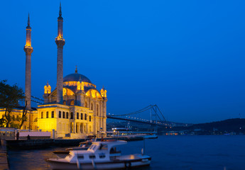 Fototapeta na wymiar Ortakoy Mosque in night lights, in the background the bridge over the Bosphorus, Istanbul