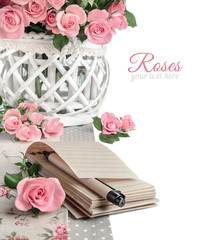 Blank notebook among beautiful pink roses, isolated on white. Ha