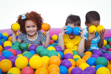 Fototapeta na wymiar Cute smiling kids in sponge ball pool