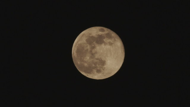 Still shot of a full moon with a brown color tone
