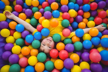 Cute smiling boy in sponge ball pool