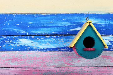 wooden bird house on grunge background.