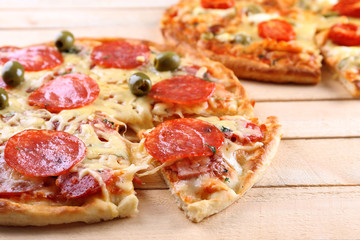 Delicious tasty pizza with cut slice, closeup
