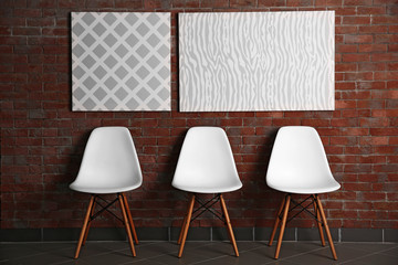 Abstract pictures with chairs on a brick wall background