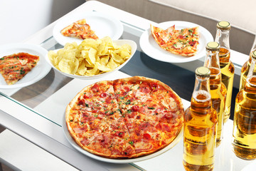 Table at home with pizza and drinks for friends