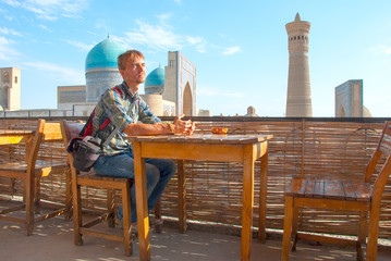 Tourist sitting in a roof-teahouse in the old city of Bukhara
