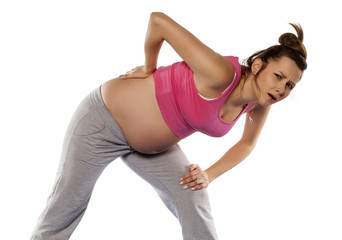 Fototapeta premium tired pregnant woman posing on a white background