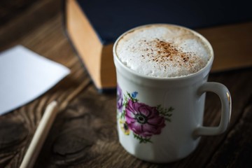 Cup of cappuccino on the wooden table