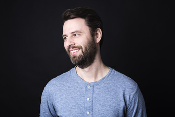 Portrait of a men with beard and mustache in studio black background