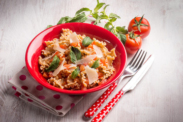 mafalda pasta with tomatoes mint and parmesan cheese flakes