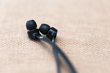Obraz na płótnie Canvas Modern flexible audio earphones on a textile