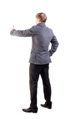 Back view of  business man in coat shows thumbs up