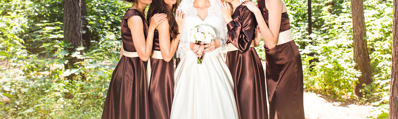 Bride and bridesmaids near trees