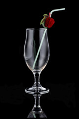 Empty glass with bendie on black mirror background
