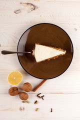 Piece of carrot cake with walnuts and white cream.