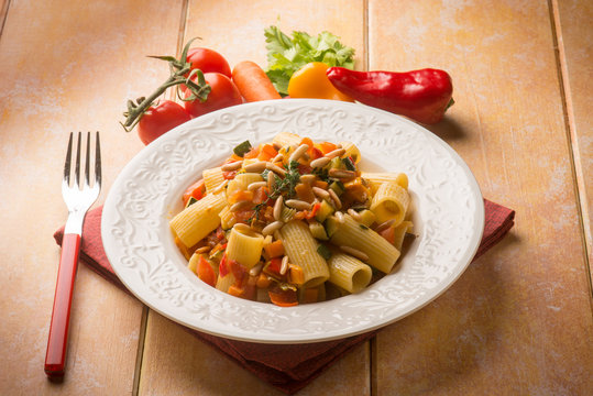pasta with mixed vegetables and pine nuts