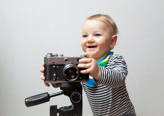 One year old boy with vintage old time photo camera