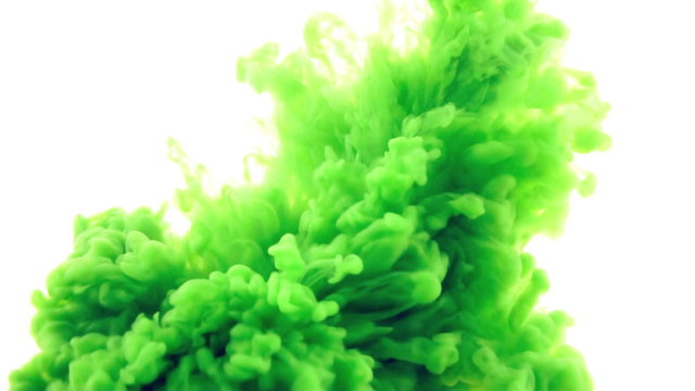 Green ink reacting in water.Creative slow motion. On a white background. 
