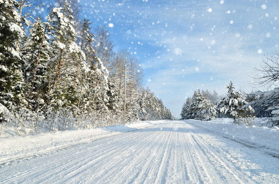 Road in a countryside in sunny winter day. Classic snow covered