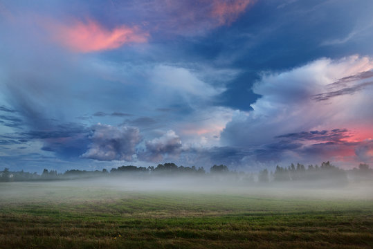 Sunset over a misty field in countryside Latvia © dumiceava