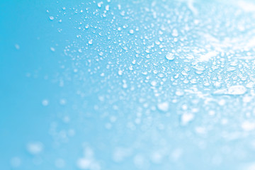 Close up rain water drops on blue sponge surface as abstract bac